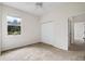Carpeted bedroom with closet and window overlooking outdoor scenery at 11144 Paradise Point Way, New Port Richey, FL 34654