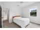 Comfortable bedroom features neutral walls, carpeted flooring, and a view through the window at 11144 Paradise Point Way, New Port Richey, FL 34654