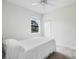 Bright bedroom with a window offering neighborhood views, featuring neutral walls and carpeted flooring at 11144 Paradise Point Way, New Port Richey, FL 34654