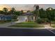 Evening shot of a well-kept single-story home, showcasing its tidy lawn and welcoming facade at 11144 Paradise Point Way, New Port Richey, FL 34654