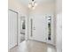 Bright foyer featuring tile flooring, a closet, and a front door with sidelights at 11144 Paradise Point Way, New Port Richey, FL 34654