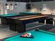 A clubhouse game room featuring billiard tables and shuffleboard for community enjoyment at 11144 Paradise Point Way, New Port Richey, FL 34654