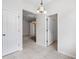 Open hallway featuring tile flooring and multiple doorways, showcasing the home's layout at 11144 Paradise Point Way, New Port Richey, FL 34654