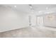 Bright, open living room features neutral carpet and paint, ceiling fan and recessed lighting at 11144 Paradise Point Way, New Port Richey, FL 34654