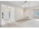 Spacious living room with carpet, neutral walls, and views into other rooms of the home at 11144 Paradise Point Way, New Port Richey, FL 34654