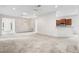 Spacious living room flows into kitchen with stainless steel appliances and breakfast bar at 11144 Paradise Point Way, New Port Richey, FL 34654