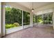 Relax in the screened porch with views of the lush landscaping at 11144 Paradise Point Way, New Port Richey, FL 34654