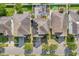 Aerial view of the property showing the roof, solar panels, driveway, backyard patio and surrounding neighborhood at 11539 Tangle Branch Ln, Gibsonton, FL 33534