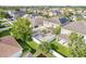 Aerial view of a backyard showcasing a geometric patio, lush green lawn, and a white privacy fence at 11539 Tangle Branch Ln, Gibsonton, FL 33534