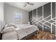 Cozy bedroom with bold accent wall, ceiling fan, and natural lighting at 11539 Tangle Branch Ln, Gibsonton, FL 33534