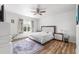 Bright bedroom featuring a ceiling fan, wood flooring, and natural light from the window at 11539 Tangle Branch Ln, Gibsonton, FL 33534
