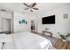 Spacious bedroom showcasing a walk-in bathroom and a modern flat-screen television at 11539 Tangle Branch Ln, Gibsonton, FL 33534