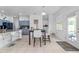 Bright breakfast nook with access to outdoor space with a table, chairs, and view of modern kitchen at 11539 Tangle Branch Ln, Gibsonton, FL 33534