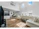 Bright and airy living room with high ceilings, hardwood floors, and modern decor open to kitchen at 11539 Tangle Branch Ln, Gibsonton, FL 33534