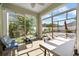 Cozy sunroom overlooking a well-maintained backyard, perfect for relaxation and enjoying the outdoors at 11539 Tangle Branch Ln, Gibsonton, FL 33534