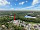 Aerial view of a wooded neighborhood featuring a pond at 12200 Hunters Lake Dr, New Port Richey, FL 34654
