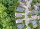 Aerial shot of a residential street surrounded by lush green trees at 12200 Hunters Lake Dr, New Port Richey, FL 34654