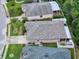 Home featuring a lush lawn, screened-in patio, complemented by white fencing and a driveway at 12200 Hunters Lake Dr, New Port Richey, FL 34654