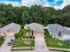 Aerial view showcasing the home's landscaping, proximity to neighboring houses and surrounding trees at 12200 Hunters Lake Dr, New Port Richey, FL 34654