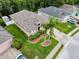 Aerial view showcasing a landscaped lawn and mature trees in the neighborhood at 12200 Hunters Lake Dr, New Port Richey, FL 34654