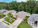 An aerial view of the property featuring a well-maintained lawn, landscaping, and neighborhood at 12200 Hunters Lake Dr, New Port Richey, FL 34654
