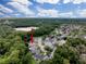 Expansive aerial view of the property, highlighting its location within a lush, green neighborhood near a serene lake at 12200 Hunters Lake Dr, New Port Richey, FL 34654