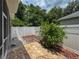 Backyard patio with brick pavers, decorative rocks and mulched garden for outdoor relaxation at 12200 Hunters Lake Dr, New Port Richey, FL 34654