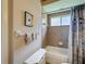 Cozy bathroom features a tub with shower, decorative blue shower curtain, and neutral tile at 12200 Hunters Lake Dr, New Port Richey, FL 34654