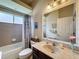 Cozy bathroom features a tub with shower and decorative blue shower curtain and marble countertop vanity at 12200 Hunters Lake Dr, New Port Richey, FL 34654