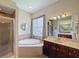 Luxurious bathroom with soaking tub, walk-in shower, and dual vanity sinks at 12200 Hunters Lake Dr, New Port Richey, FL 34654