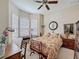 Cozy bedroom with bay windows, a decorative bed frame, and a desk area, creating a relaxing space at 12200 Hunters Lake Dr, New Port Richey, FL 34654