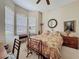 Bright bedroom with bay windows, a decorative bed frame, and a desk area, creating a relaxing space at 12200 Hunters Lake Dr, New Port Richey, FL 34654