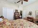 Spacious bedroom with a ceiling fan, closet, and a desk, providing ample storage and functional space at 12200 Hunters Lake Dr, New Port Richey, FL 34654