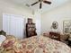 Bright bedroom featuring a ceiling fan, closet, and a desk, offering a comfortable and functional space at 12200 Hunters Lake Dr, New Port Richey, FL 34654