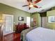 Bright bedroom featuring hardwood floors, an attached patio, and modern decor at 12200 Hunters Lake Dr, New Port Richey, FL 34654