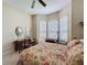 Cozy bedroom featuring a bay window, desk, and floral bedding, offering a comfortable and inviting space at 12200 Hunters Lake Dr, New Port Richey, FL 34654