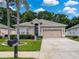 Charming single-story home features a well-manicured lawn and a two-car garage at 12200 Hunters Lake Dr, New Port Richey, FL 34654
