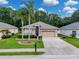 Inviting single-story home boasting lush landscaping, a well-maintained lawn, and a spacious driveway for convenient parking at 12200 Hunters Lake Dr, New Port Richey, FL 34654