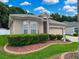 Attractive single-story home boasting mature landscaping, lush shrubs, an attached two-car garage, and a welcoming front entrance at 12200 Hunters Lake Dr, New Port Richey, FL 34654