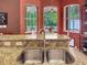 Granite countertop and sink overlooking breakfast nook with lots of natural light at 12200 Hunters Lake Dr, New Port Richey, FL 34654
