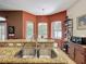 Spacious kitchen sink with granite countertops and access to a cozy breakfast nook at 12200 Hunters Lake Dr, New Port Richey, FL 34654