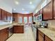 Spacious kitchen featuring granite countertops, stainless appliances, and a sunlit breakfast nook at 12200 Hunters Lake Dr, New Port Richey, FL 34654