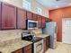 Beautiful kitchen featuring stainless steel appliances, granite countertops, and stained wood cabinetry at 12200 Hunters Lake Dr, New Port Richey, FL 34654
