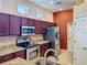 Kitchen with stainless steel appliances, granite countertops, and dark wood cabinets at 12200 Hunters Lake Dr, New Port Richey, FL 34654