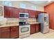 Well-appointed kitchen with stainless steel appliances, granite counters, and wood cabinetry at 12200 Hunters Lake Dr, New Port Richey, FL 34654