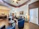 Bright living room with hardwood floors, ceiling fan, and comfortable leather seating at 12200 Hunters Lake Dr, New Port Richey, FL 34654