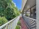 Charming patio area with a white lattice fence, greenery and serene outdoor view at 12200 Hunters Lake Dr, New Port Richey, FL 34654