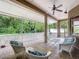Relaxing screened-in patio with tile flooring, ceiling fan and comfortable wicker seating area at 12200 Hunters Lake Dr, New Port Richey, FL 34654