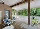 Inviting covered patio with tiled floors, comfortable seating, and peaceful outdoor views at 12200 Hunters Lake Dr, New Port Richey, FL 34654
