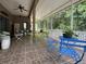 Spacious screened patio offering shaded outdoor living with tiled floors and overhead fan at 12200 Hunters Lake Dr, New Port Richey, FL 34654